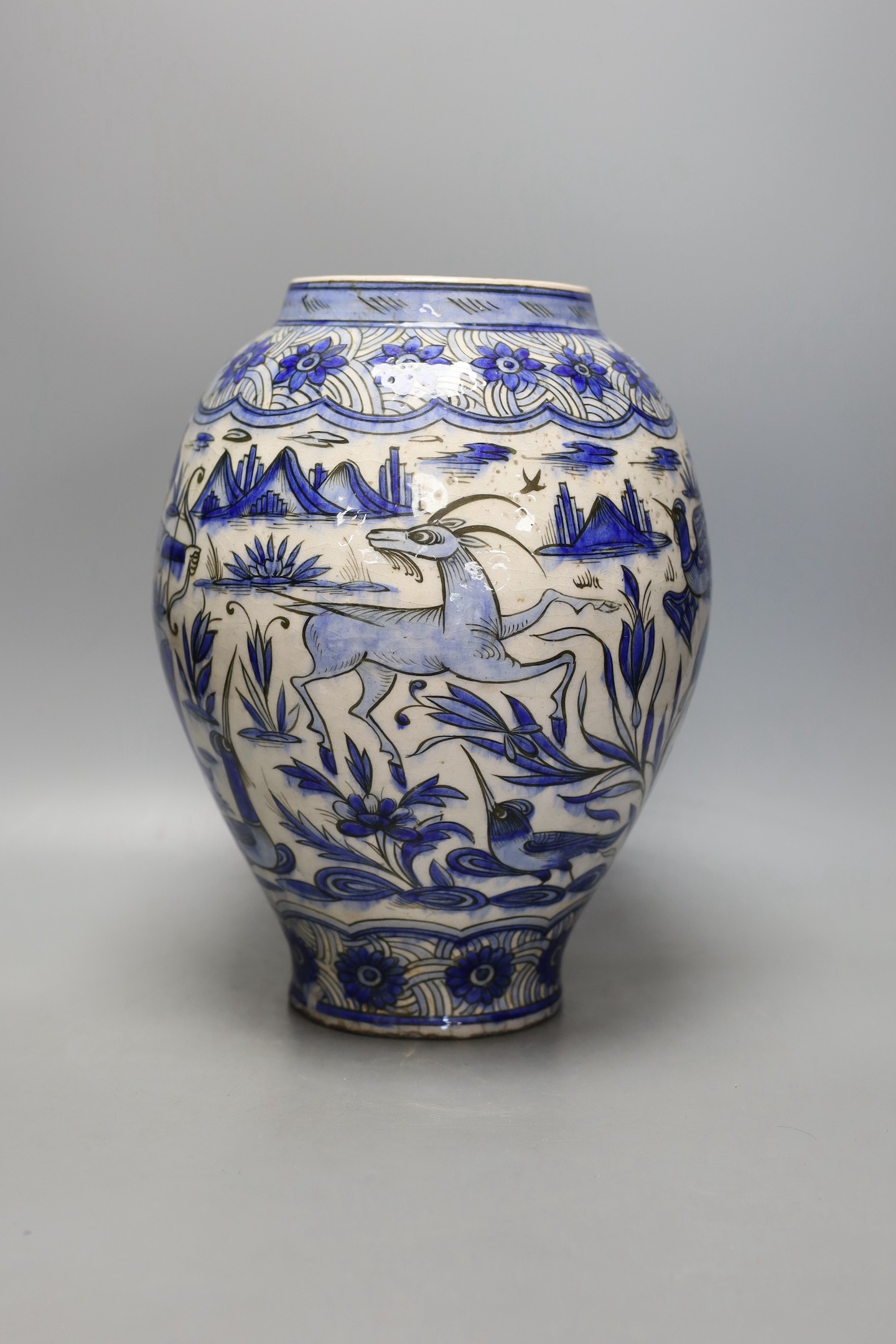 A large Persian pottery jar ‘hunting scene’ jar, Safavid style, 19th century, 33cm